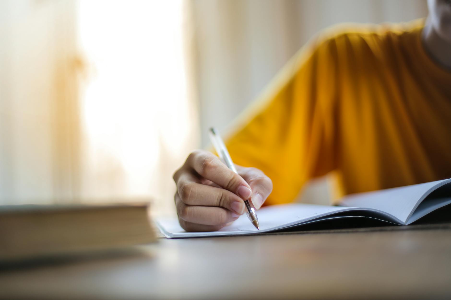 person writing on laptop