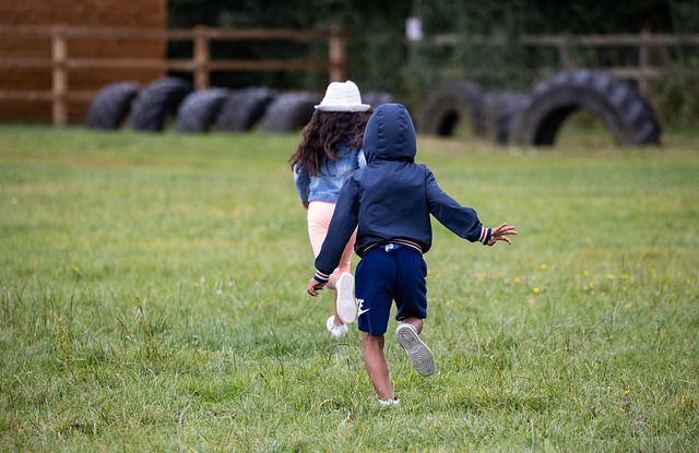 children playing energetically in a park (rambunctious nyt)