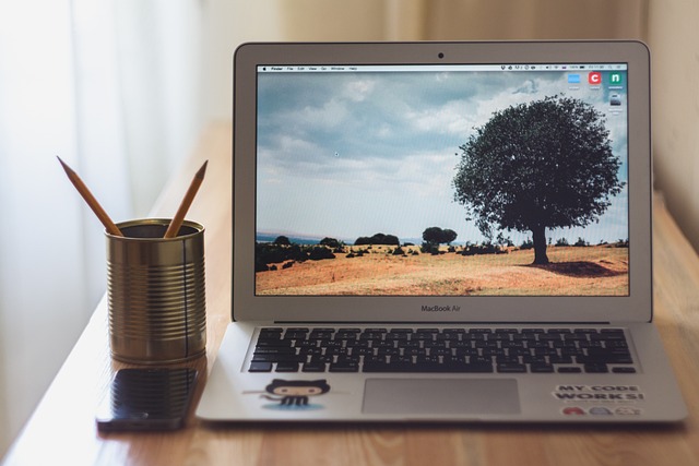 MacBook Air and MacBook Pro side-by-side on a desk with a user interacting