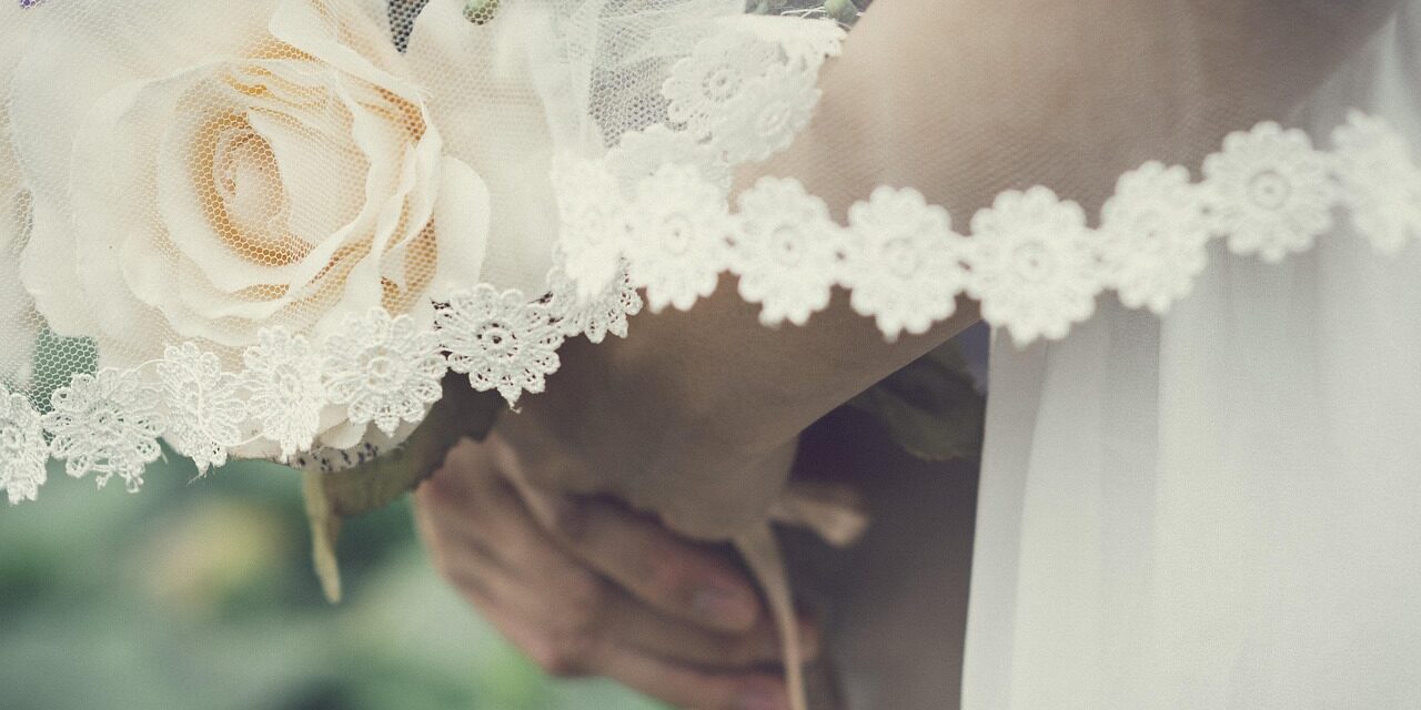 wedding guest holding flowers