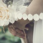 wedding guest holding flowers