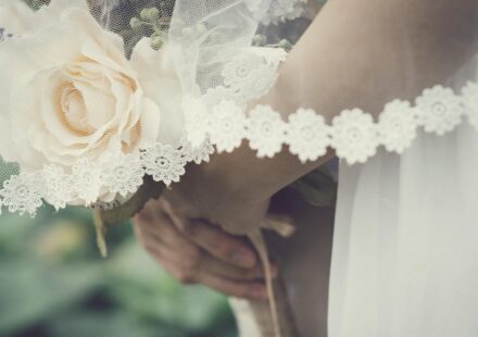 wedding guest holding flowers