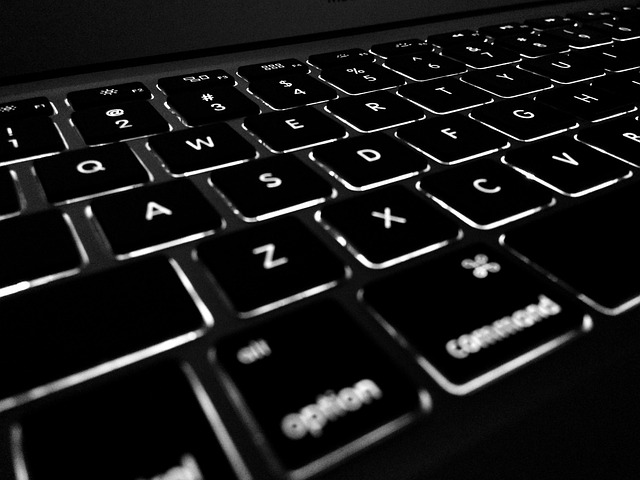 Close-up of an LCD computer monitor showing noticeable backlight bleed in the corners (dark shadow on computer screen)