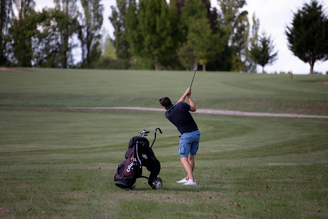 Golfer practicing swing with alignment sticks and a weighted training club