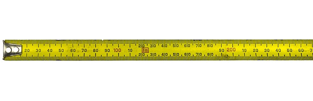Measuring tape laid out across a gravel path project area, showing length and width measurements (figuring gravel)
