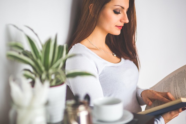 Person reading a tech review on a laptop, comparing different gadgets