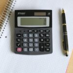 person using calculator for shopping