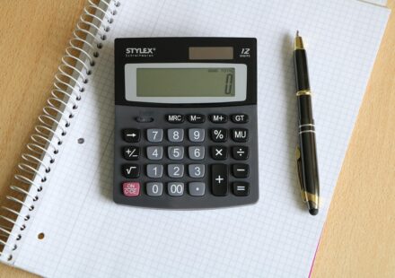 person using calculator for shopping