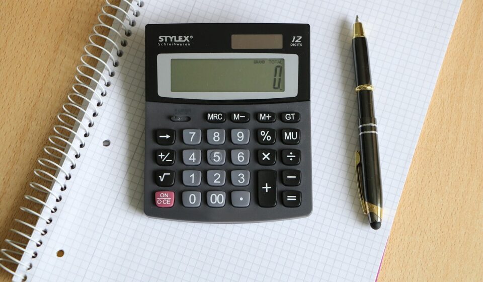 person using calculator for shopping