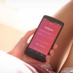 woman using period tracker app on phone