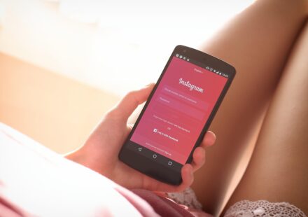 woman using period tracker app on phone