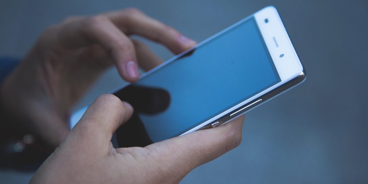 woman using period tracker app on phone