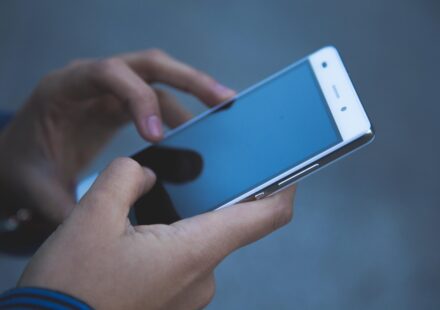 woman using period tracker app on phone
