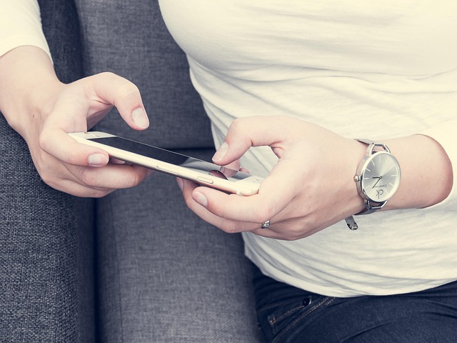 Woman using a smart ring and a skincare wand, representing health and wellness gadgets for women